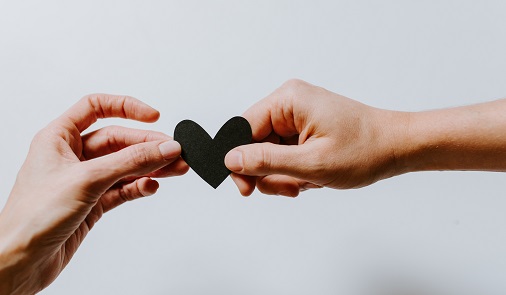 Two hands holding a heart